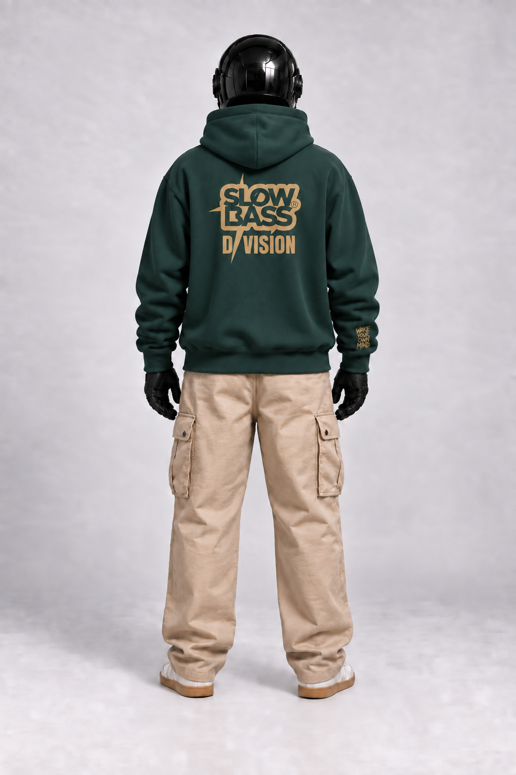 Rear view of SVO wearing the pine green SVO hoodie, showing the large gold back logo with beige cargo trousers.