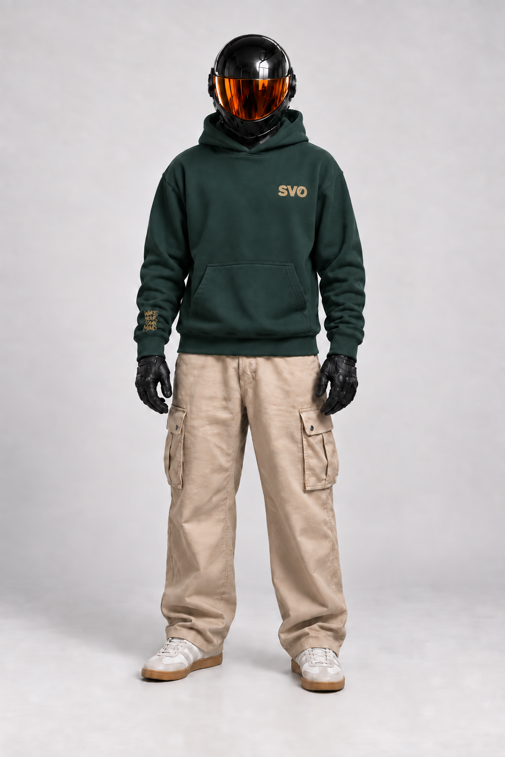 Front view of SVO wearing the pine green SVO oversized hoodie with beige cargo trousers.