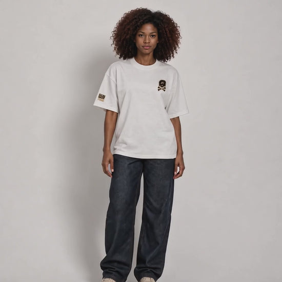 All views of Dawn wearing the white ISSUE #1 SKULL oversized T-shirt with dark loose-fitting trousers.