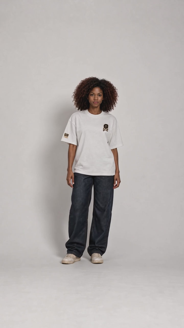 All views of Dawn wearing the white ISSUE #1 SKULL oversized T-shirt with dark loose-fitting trousers.